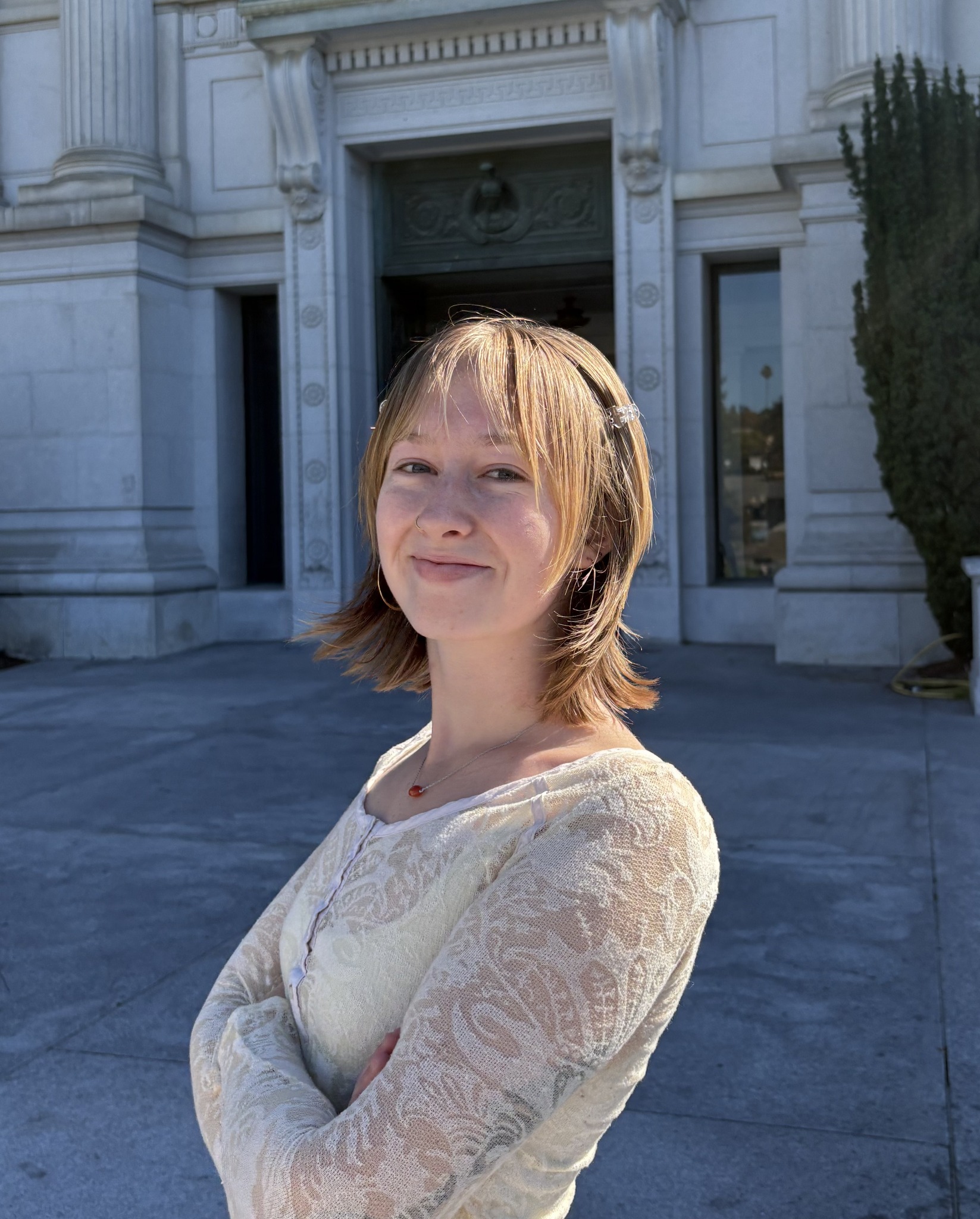 Ella Manthorne outside a columned building